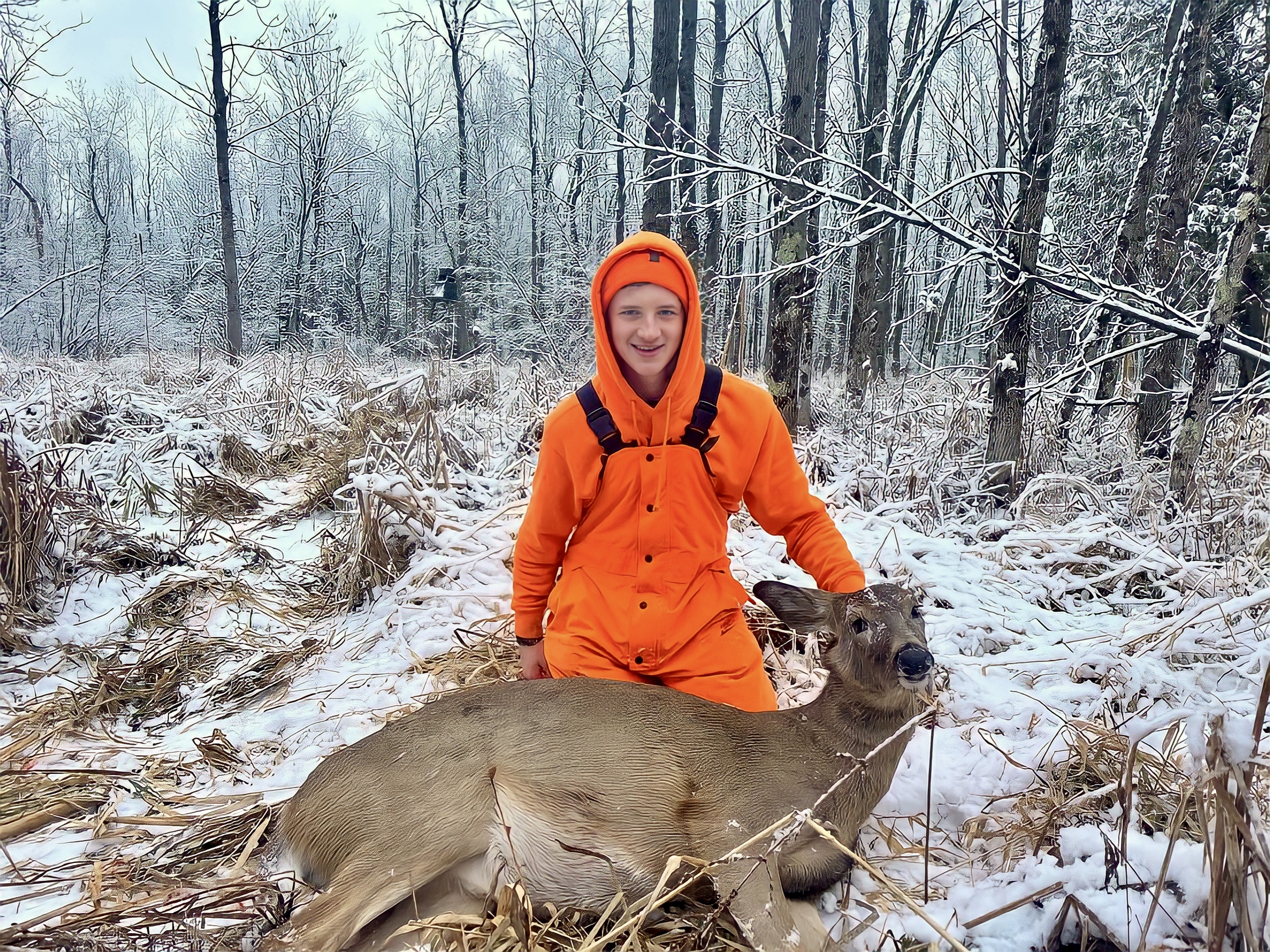 austin sitting behind a deer